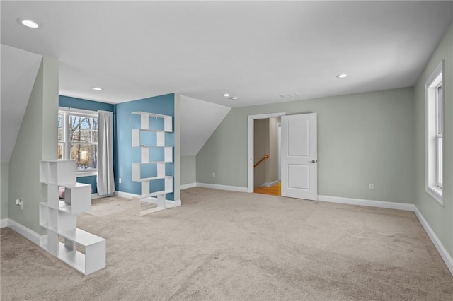 additional living space featuring light carpet, baseboards, and recessed lighting