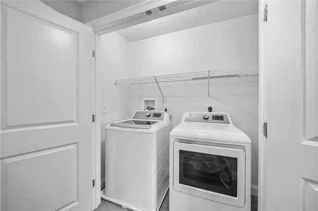 washroom featuring laundry area and washing machine and dryer