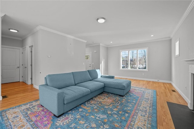 living room featuring ornamental molding, wood finished floors, a fireplace with flush hearth, and baseboards