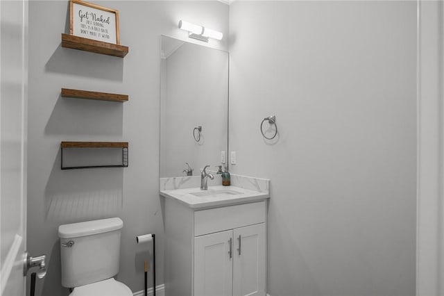 bathroom featuring toilet and vanity