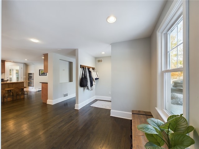 entryway featuring visible vents, baseboards, dark wood-type flooring, and recessed lighting