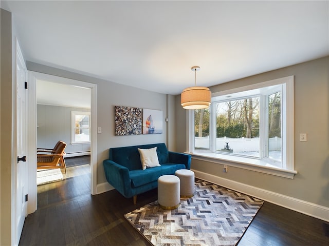 sitting room with dark wood-style floors, visible vents, and baseboards