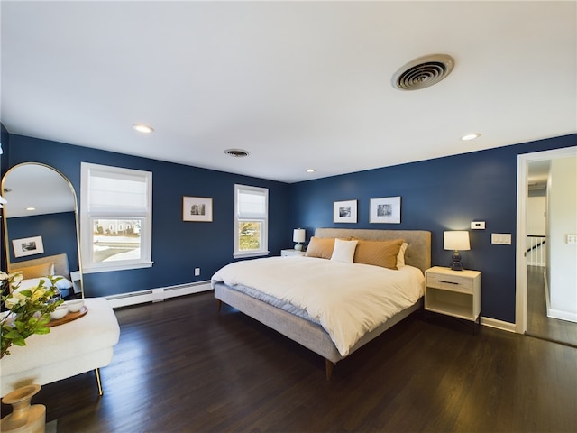 bedroom featuring baseboards, a baseboard radiator, visible vents, and wood finished floors