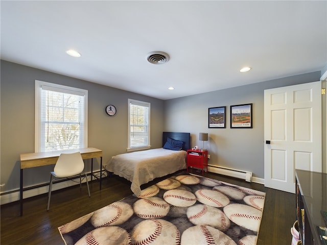 bedroom with dark wood-style flooring, a baseboard radiator, visible vents, a baseboard heating unit, and baseboards