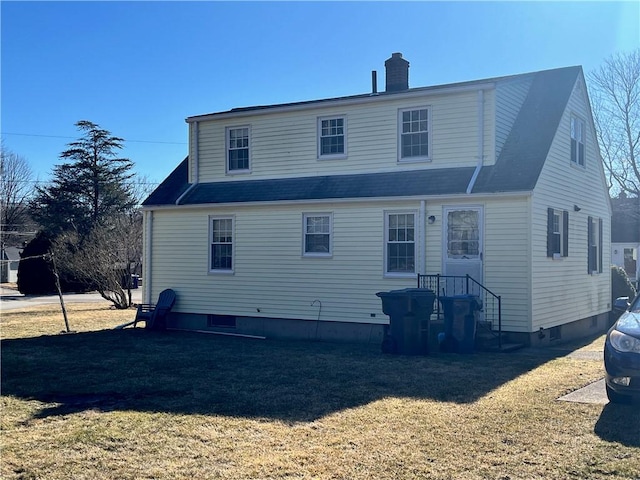 back of house with a chimney and a yard