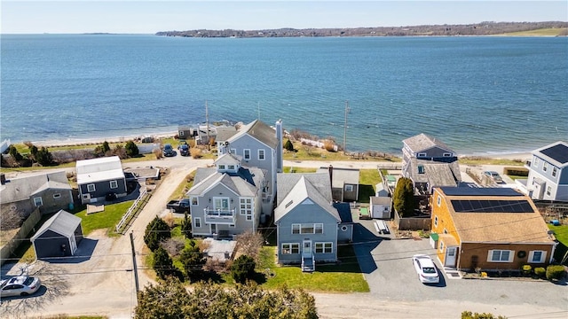 drone / aerial view featuring a water view and a residential view