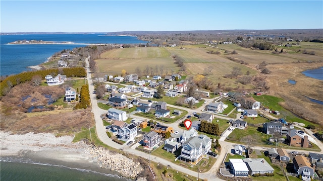 drone / aerial view featuring a residential view and a water view