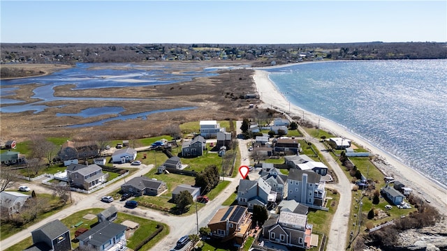 birds eye view of property featuring a residential view, a water view, and a beach view