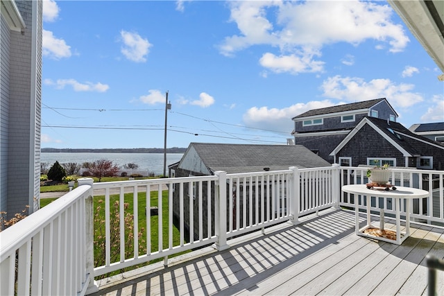 deck featuring a water view and a yard