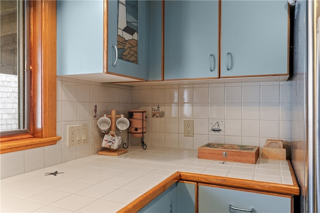 kitchen with tile counters and decorative backsplash