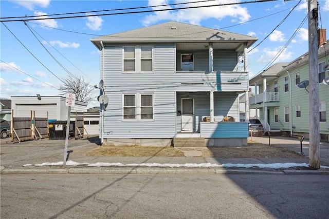 view of front of house featuring covered porch and a balcony