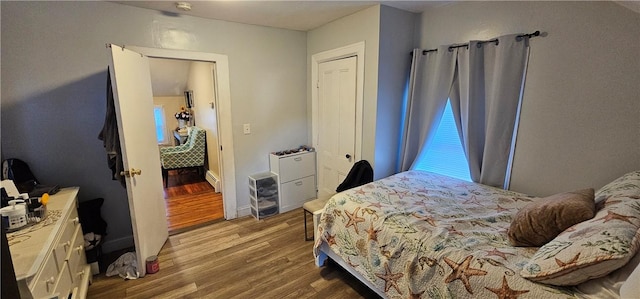 bedroom featuring wood finished floors and baseboards