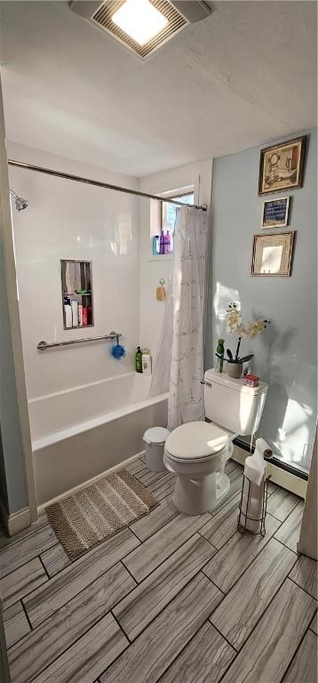 bathroom with toilet, shower / tub combo, and visible vents