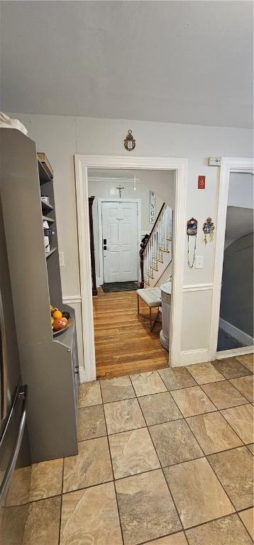 interior space featuring light tile patterned floors and stairway