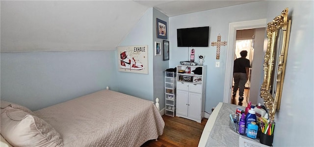 bedroom with dark wood-type flooring and lofted ceiling