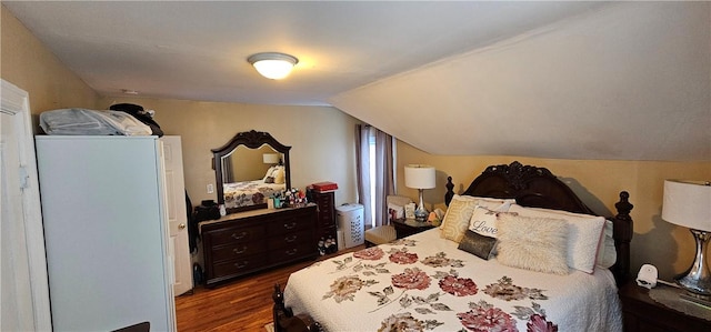 bedroom featuring dark wood finished floors and vaulted ceiling