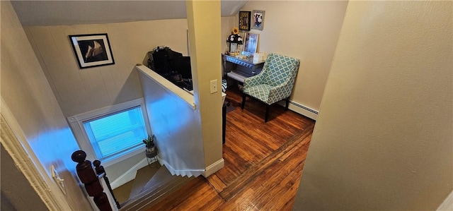 interior space featuring a baseboard radiator, wood finished floors, and baseboards