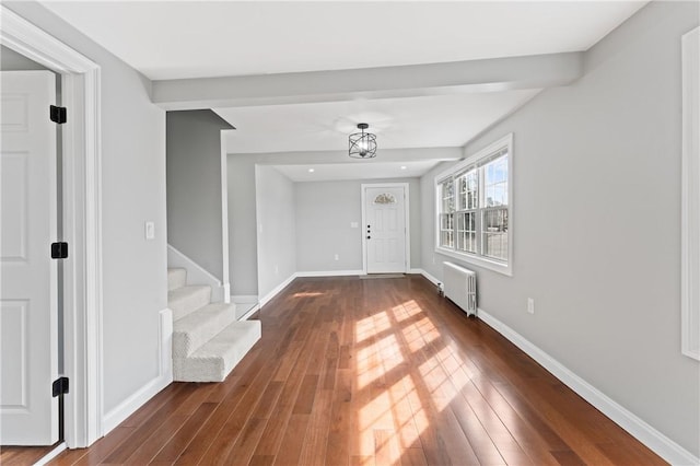 foyer with radiator heating unit, stairs, baseboards, and dark wood finished floors