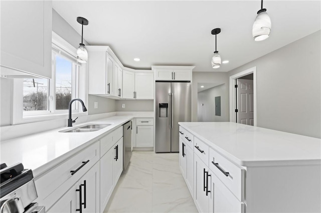 kitchen featuring a sink, white cabinetry, marble finish floor, appliances with stainless steel finishes, and pendant lighting