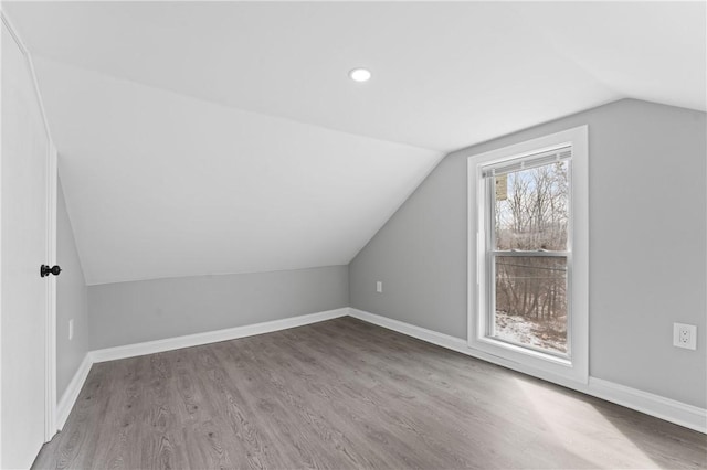 bonus room with vaulted ceiling, recessed lighting, light wood-style flooring, and baseboards