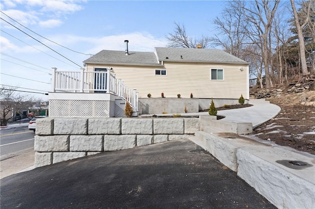 rear view of house with a deck and stairs