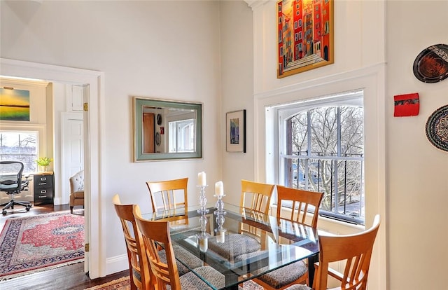 dining space featuring wood finished floors and baseboards