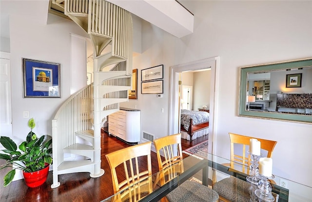 dining room featuring stairs, visible vents, and dark wood finished floors