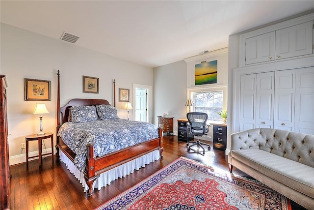 bedroom with dark wood-style floors, baseboards, and visible vents