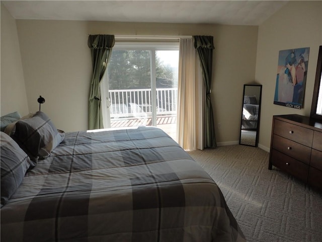 carpeted bedroom featuring access to exterior and baseboards