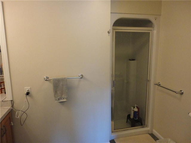 bathroom featuring a shower stall and vanity