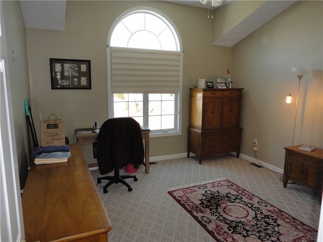 home office with light colored carpet and baseboards