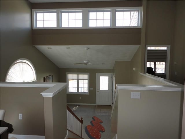 kitchen featuring ceiling fan and baseboards