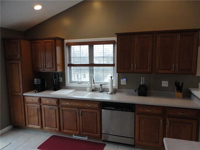 kitchen featuring visible vents, dishwasher, lofted ceiling, light countertops, and light tile patterned flooring