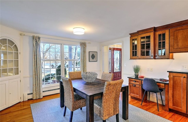 dining area featuring light wood-type flooring and a baseboard radiator