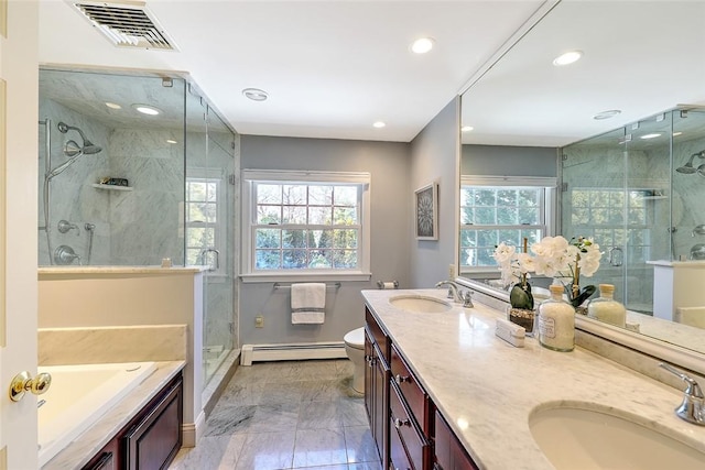 full bath with plenty of natural light, a baseboard radiator, visible vents, and a sink