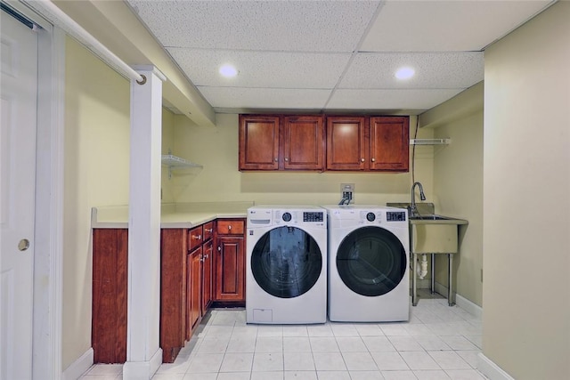 washroom featuring light tile patterned flooring, cabinet space, baseboards, and separate washer and dryer