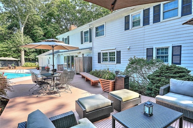 view of patio featuring a deck, outdoor dining space, an outdoor living space, and an outdoor pool