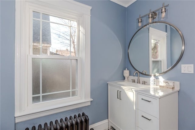 bathroom with radiator heating unit and vanity