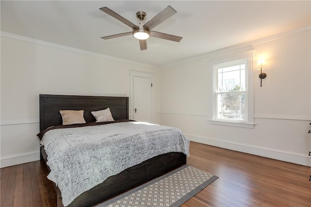 bedroom with ornamental molding, baseboards, and hardwood / wood-style floors