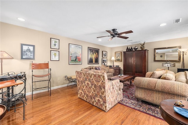 living room featuring recessed lighting, visible vents, light wood-style flooring, and baseboards