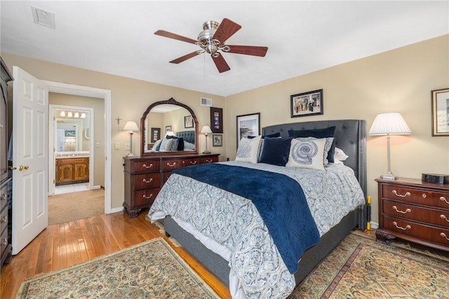 bedroom with wood-type flooring, visible vents, ceiling fan, and baseboards