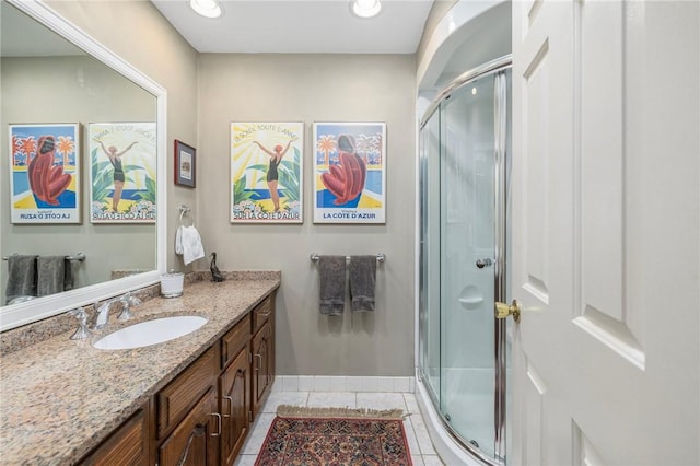 bathroom featuring recessed lighting, a shower stall, vanity, baseboards, and tile patterned floors