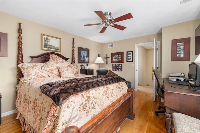 bedroom featuring visible vents, light wood finished floors, a ceiling fan, and baseboards