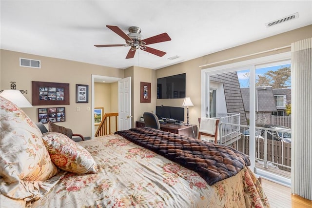 bedroom featuring access to exterior, light wood-style flooring, and visible vents