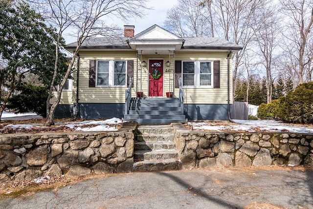 bungalow-style house featuring a chimney