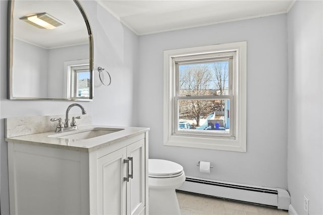 bathroom with a baseboard heating unit, visible vents, vanity, and a healthy amount of sunlight