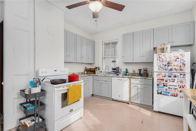 kitchen with gray cabinets, white appliances, a sink, and a ceiling fan