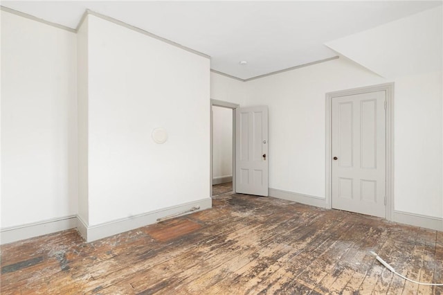 unfurnished room featuring wood-type flooring and baseboards