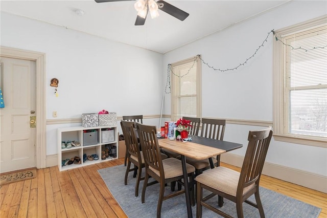 dining area with ceiling fan, hardwood / wood-style floors, and baseboards