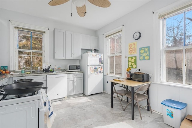 kitchen featuring ceiling fan, marble finish floor, white appliances, and light countertops